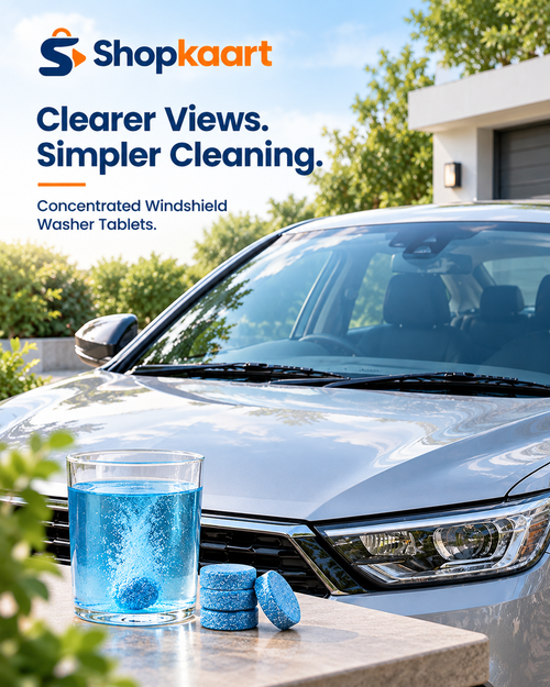 A silver car parked outdoors with a glass of blue liquid and two blue cleaning tablets in the foreground. Large text at the top reads 'Shopkaart Clearer Views.