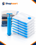 A set of clear plastic clothes storage bags with blue valves and pumps, shown with folded clothes inside a bag and a blue manual pump. The Shopkaart logo is visible in the top left corner.