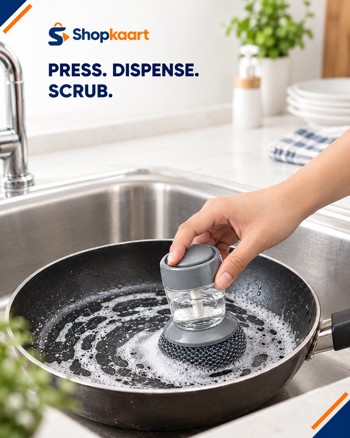 A hand uses a Shopkaart automatic dishwashing scrubber inside a black frying pan filled with soapy water in a kitchen sink. The Shopkaart brand logo and the text 'PRESS.